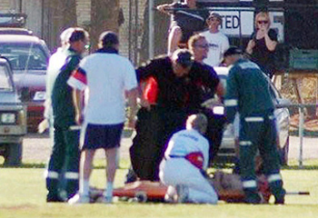 Roberts gets tended to after injurying his foot when attempting a naked cartwheel.