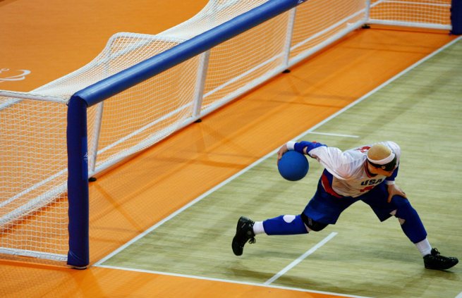 This event is called goalball and all the players are blind or wearing blindfolds. There is a little bell inside the ball to alert players to its presence.